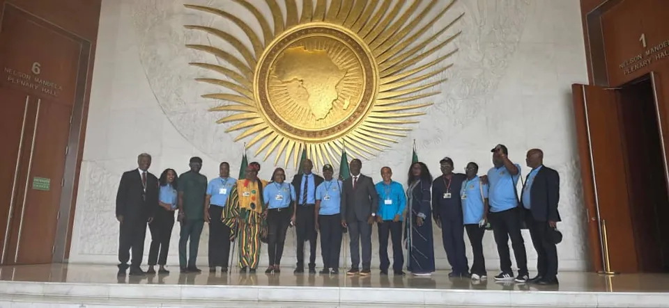 Delegates beneath the golden African Union emblem.
